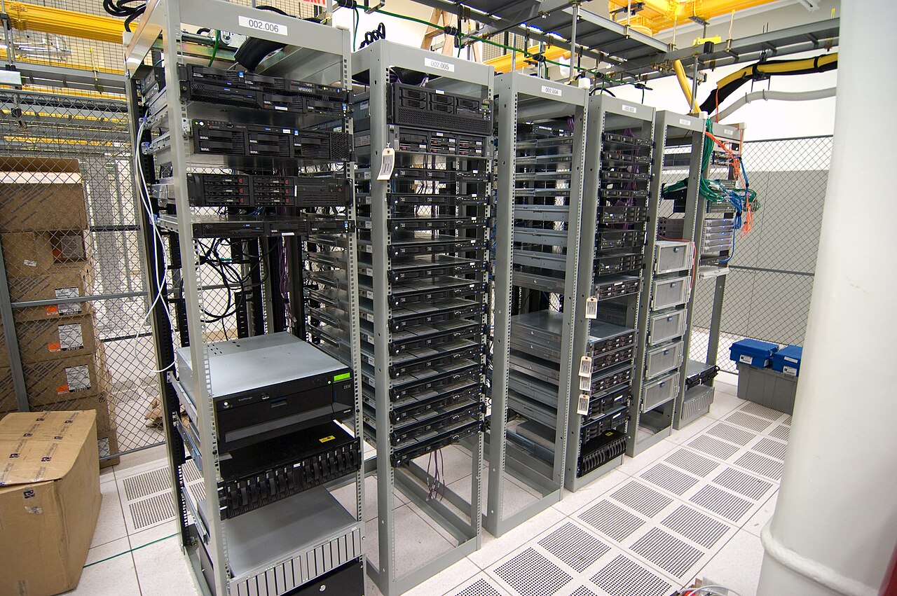 Rows of computer servers and network equipment in racks